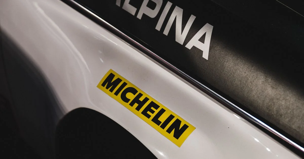 Vue détaillée d'un autocollant Michelin sur une voiture de course mettant en avant le style de la marque.